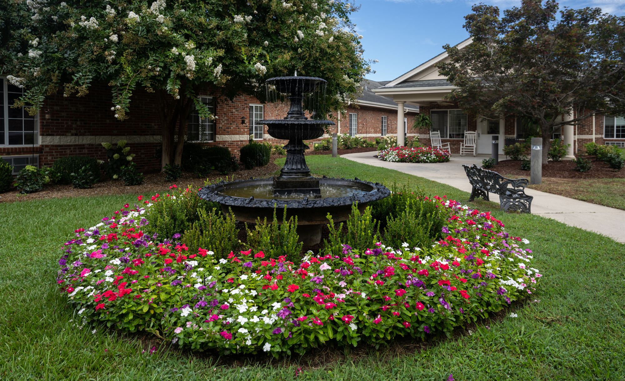 The garden fountain ringed with impatiens