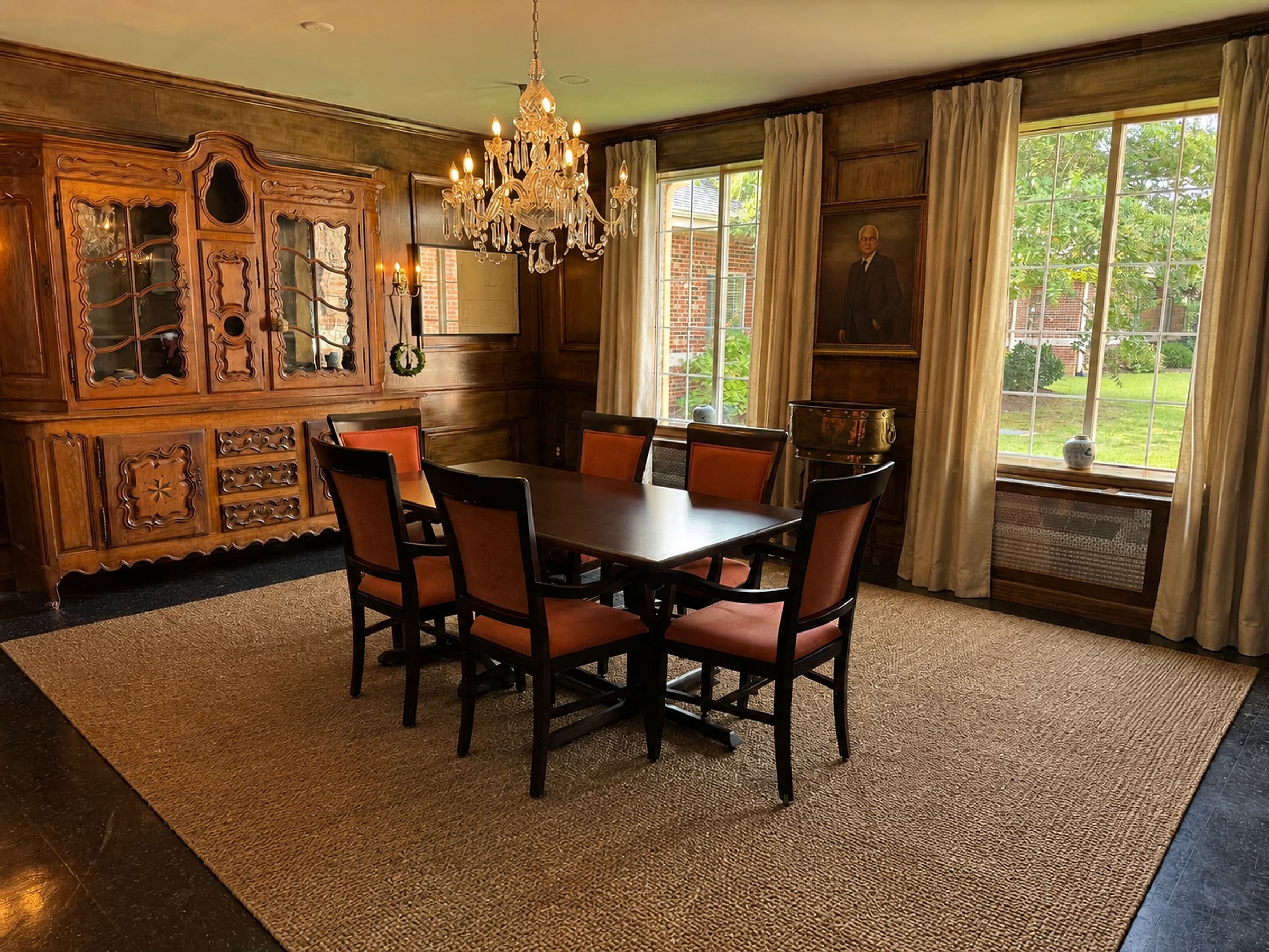 Oak Hill's wood-paneled private dining room under a crystal chandelier