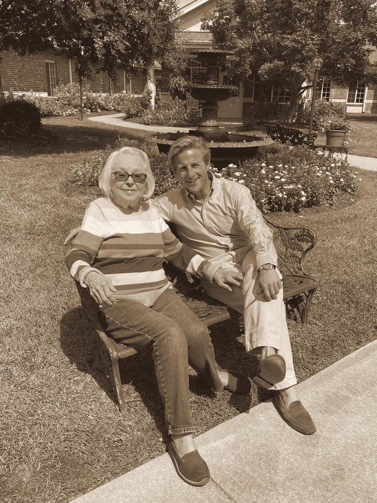 Laurie Stephenson and her grandson Barnes on a bench by the courtyard fountain